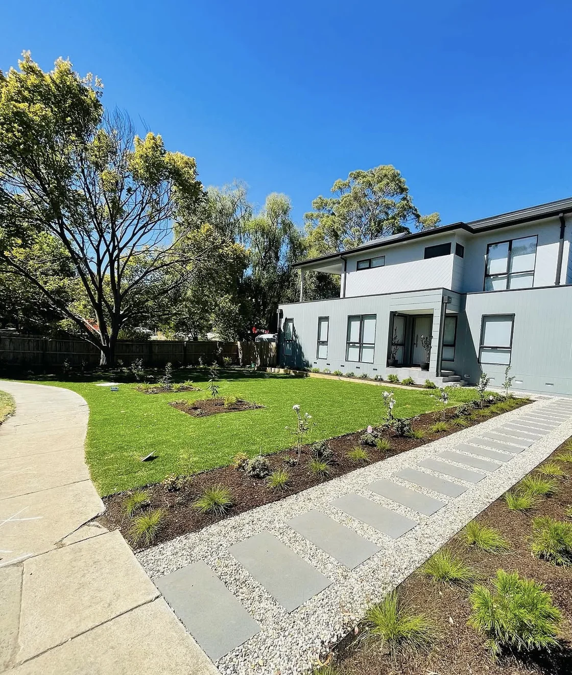 Contemporary front garden in Ferntree Gully, with lawn, planting and a stone path