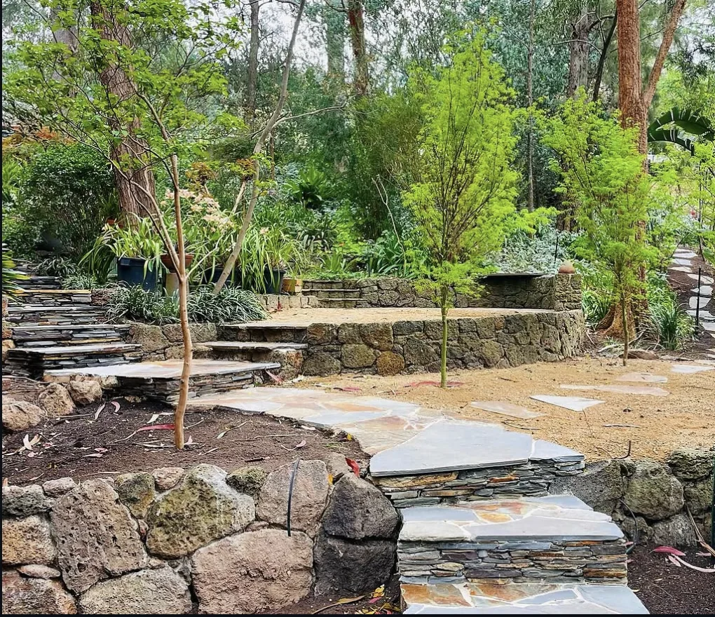 Stone steps and retaining wall in a planted garden